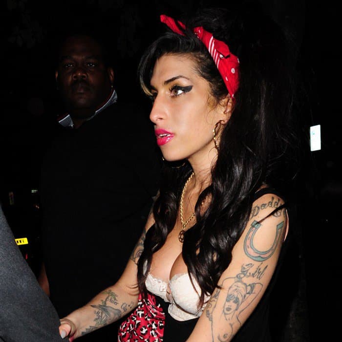 Amy Winehouse wears her scarf as a headband