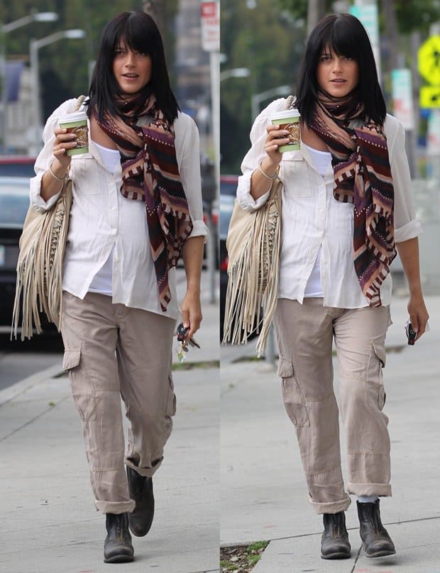Pregnant Selma Blair in a white shirt paired with a long safari scarf, boots, and cargo pants
