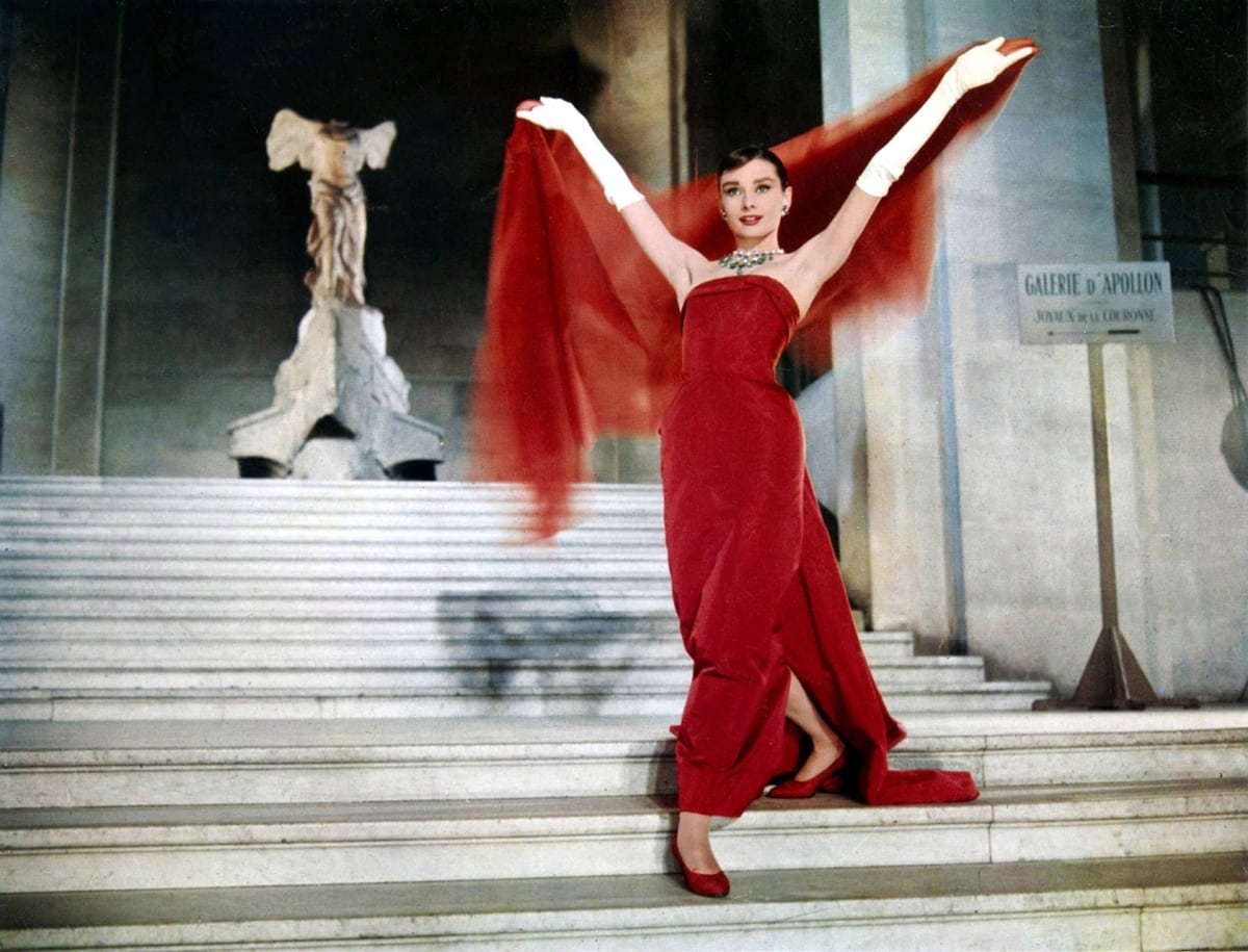In the 1957 movie "Funny Face," Audrey Hepburn as bookstore clerk turned fashion model Jo Stockton, wears a red scarf wrapped around her neck while dancing in Paris