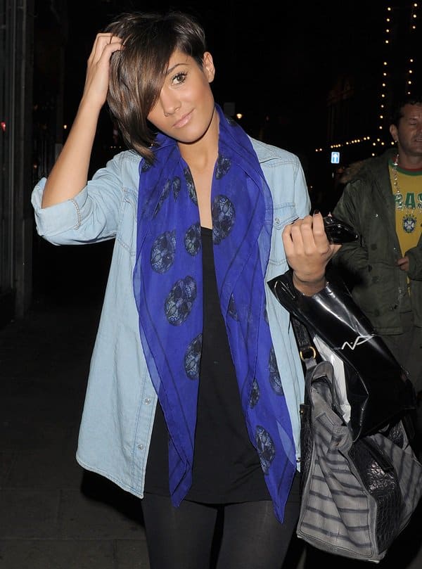 Frankie Sandford wears a blue Alexander McQueen Skull scarf while leaving a recording studio in London on April 8, 2010