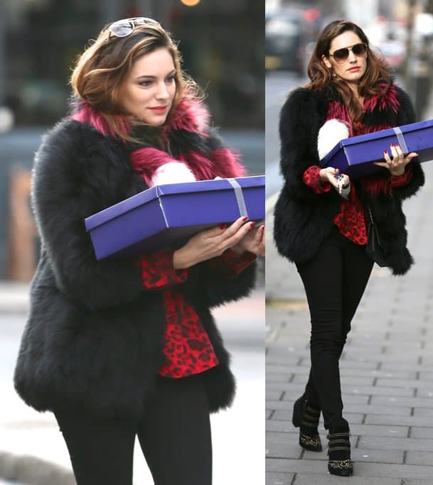 Kelly Brook wears a tri-colored scarf with a fur coat, skinny jeans and studded boots