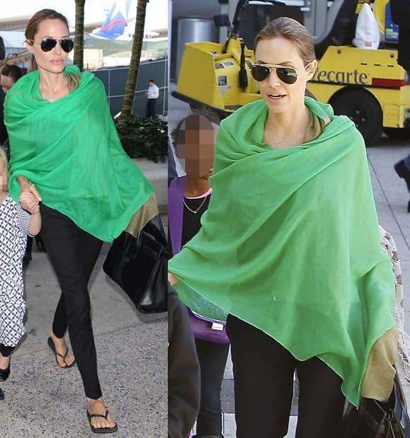 Angelina Jolie wears a bright green wrap with black pants