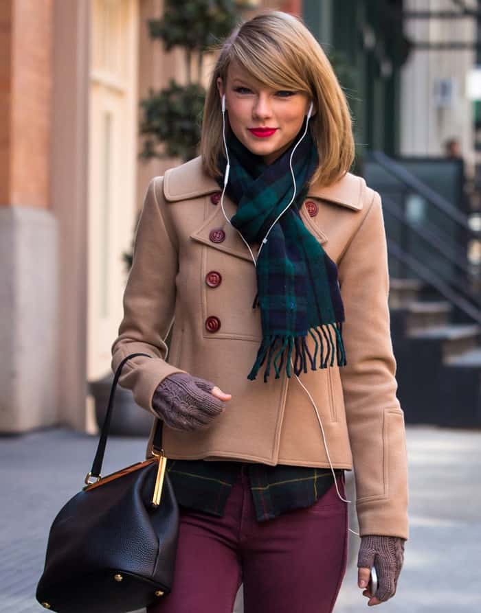 Taylor Swift was seen sporting a shoulder-length bob hairstyle with side-swept bangs paired with a green tartan scarf draped around her neck