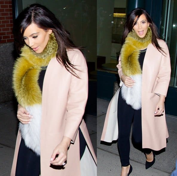 Kim Kardashian wearing a yellow fur scarf and an oversized pastel-pink topper