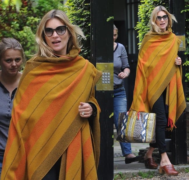 Kate Moss steps out of her London home in a pair of clogs and a cozy blanket coat
