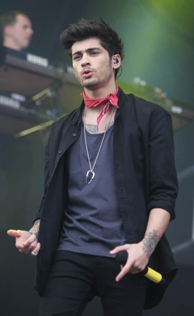 Zayn Malik wears a red neckerchief with his black outfit while performing in Glasgow