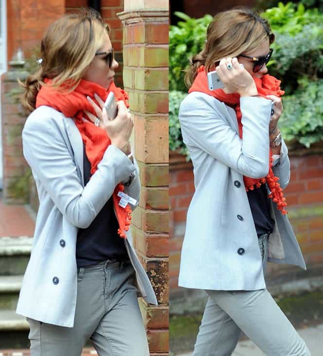 Abbey Clancy wears a bright orange scarf while leaving her home in London