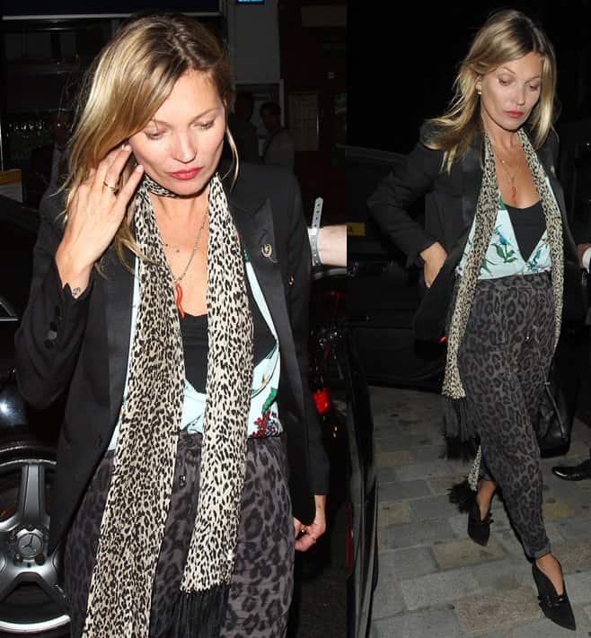 Kate Moss showcased her impeccable sense of style as she paired a pair of bold animal-print trousers with a light blue floral blouse, creating a unique and striking look