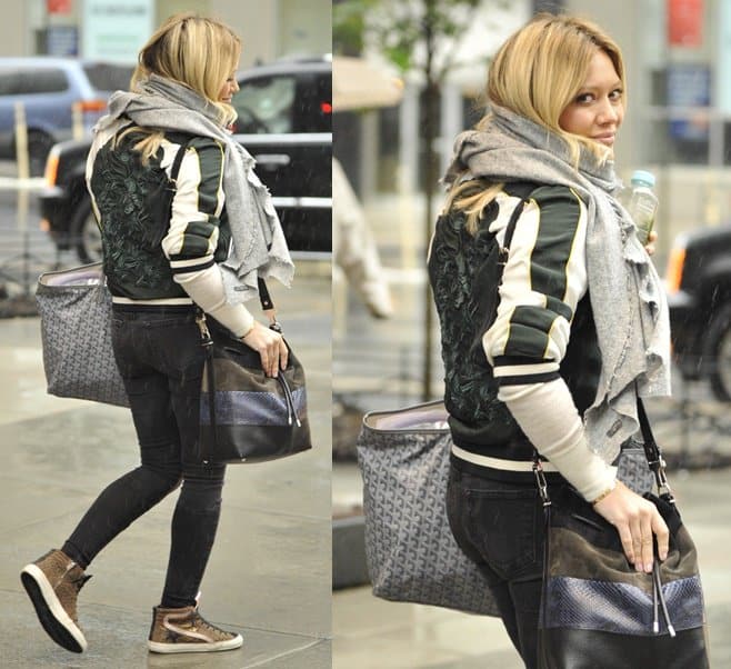 Hilary Duff wears Golden Goose leopard suede slide sneakers and carries a Proenza Schouler python and leather bucket bag and Goyard St Louis tote