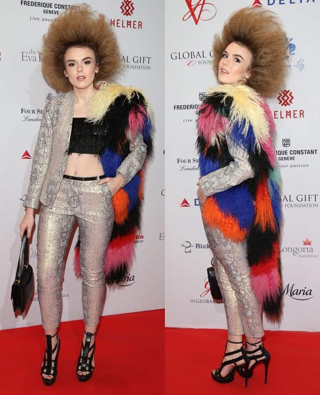 Tallia Storm looked striking in a snakeskin-printed blazer and pants paired with a black fringed bandeau styled with frizzed-up Afro-like hair and a colorful furry boa