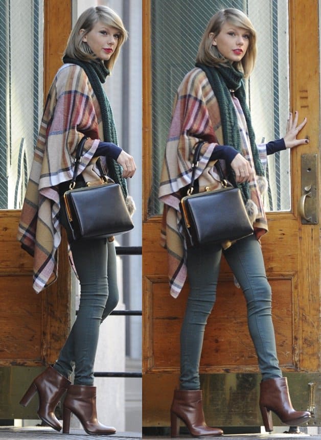 Taylor Swift wears a Topshop checked cape with a chunky cable knit pom scarf, Hudson skinny jeans and brown Prada ankle boots