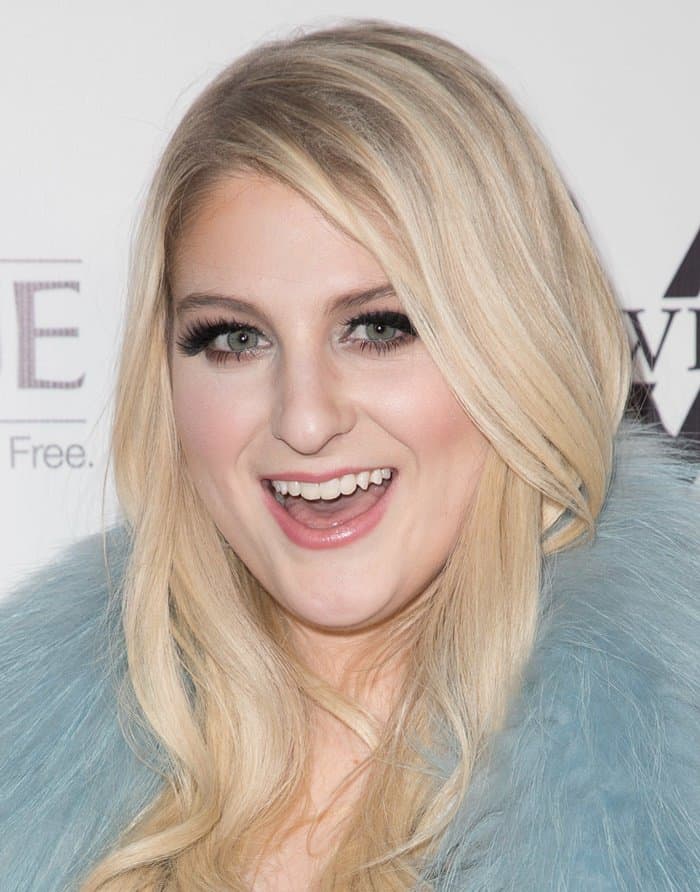 Meghan Trainor in a light blue fur scarf attends her album release party